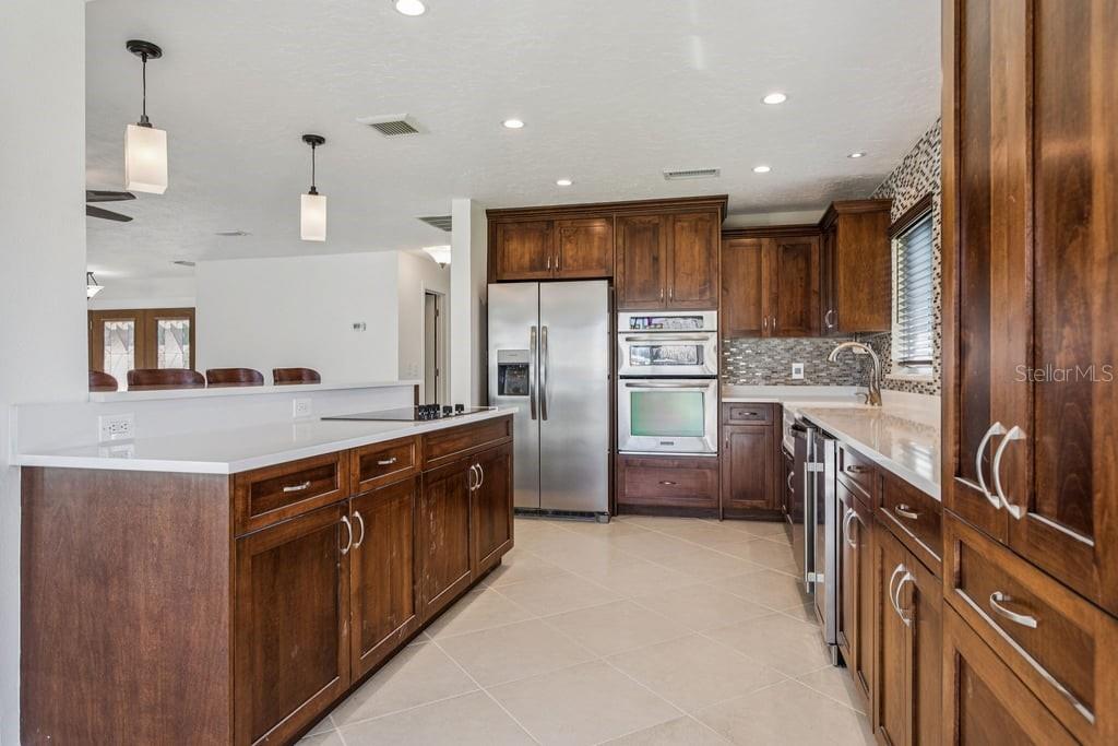 3734 Topsail Trail New Port Richey, FL 34652 - Photo 10 of 65 a kitchen with stainless steel appliances granite countertop a refrigerator a sink a stove and a refrigerator