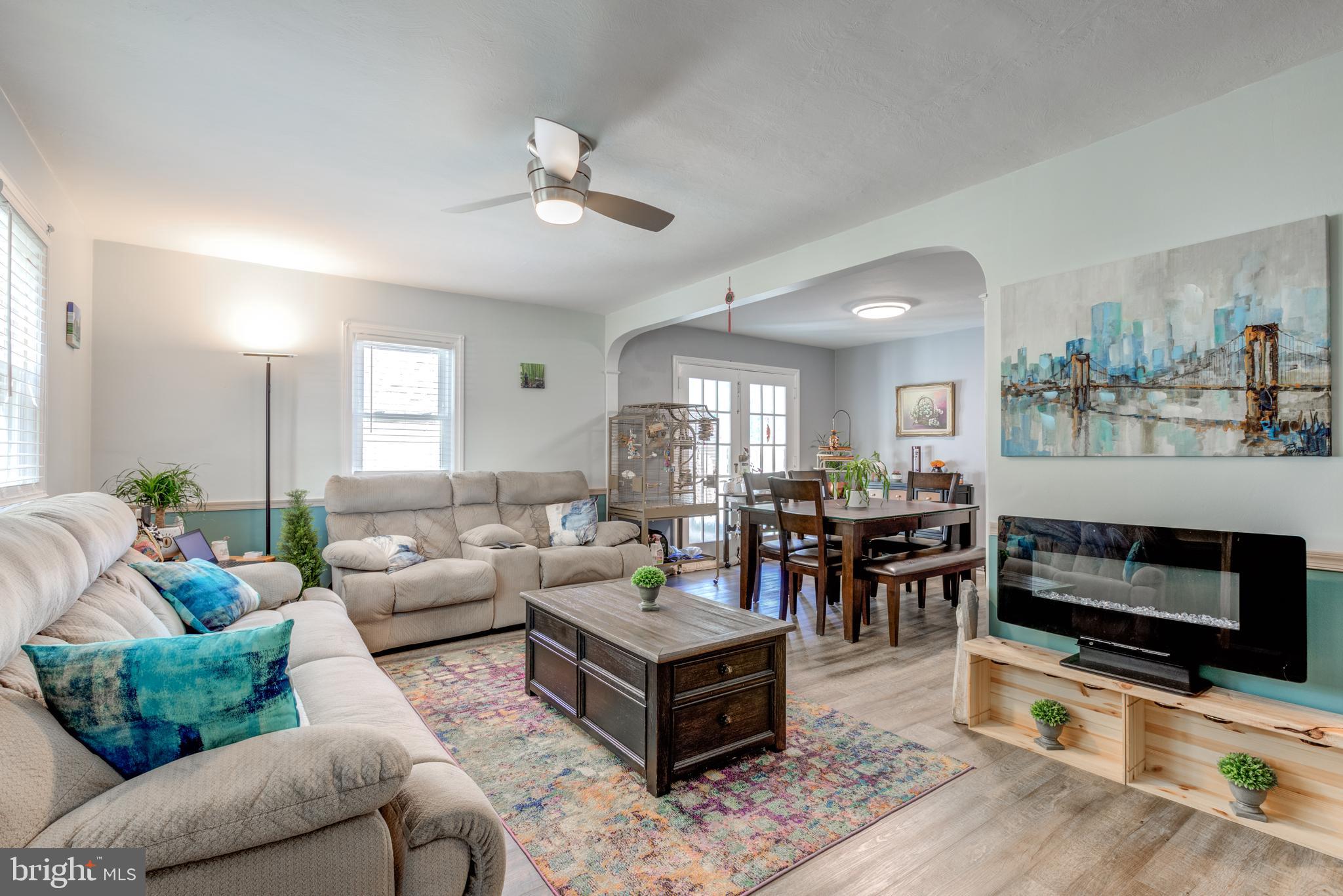 121 Leconey Circle Palmyra, NJ 08065 - Photo 4 of 33 a living room with furniture and a flat screen tv with kitchen view