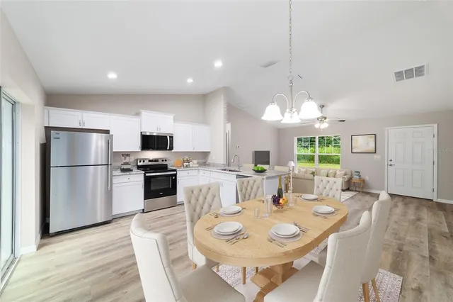 a large kitchen with a table and chairs