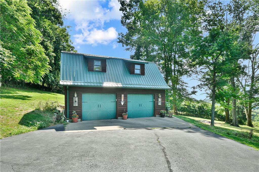 69 Lover Jonestown Road Charleroi, PA 15022 - Photo 5 of 46 Recently stained natural pine logs and a durable metal roof for timeless appeal and low maintenance.
