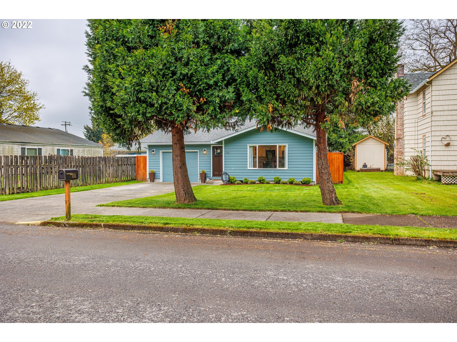 711 North Main Avenue Ridgefield, WA 98642 - Photo 1 of 14 a view of a house with a big yard and large trees
