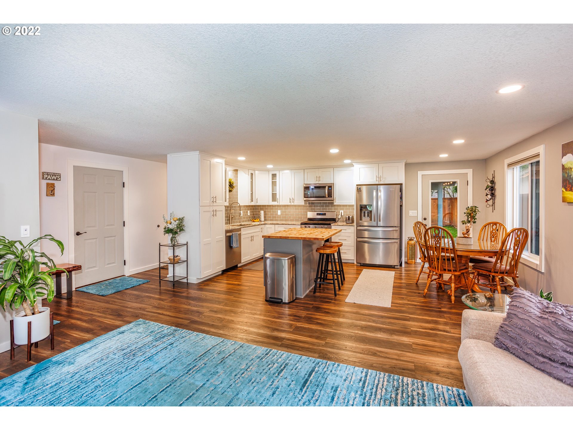 711 North Main Avenue Ridgefield, WA 98642 - Photo 5 of 14 a living room with furniture wooden floor and a kitchen view
