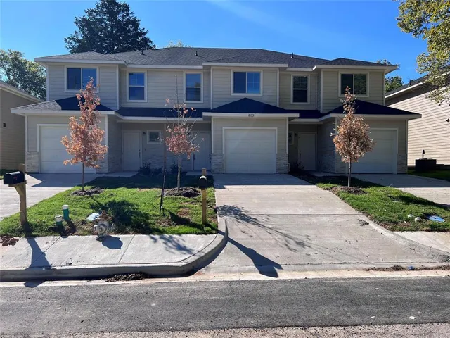 a view of a yard in front view of a house