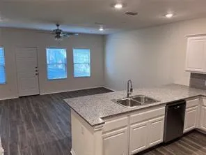a hallway with wooden floor and staircase