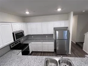 a close view of kitchen countertops with cabinets and wooden floor