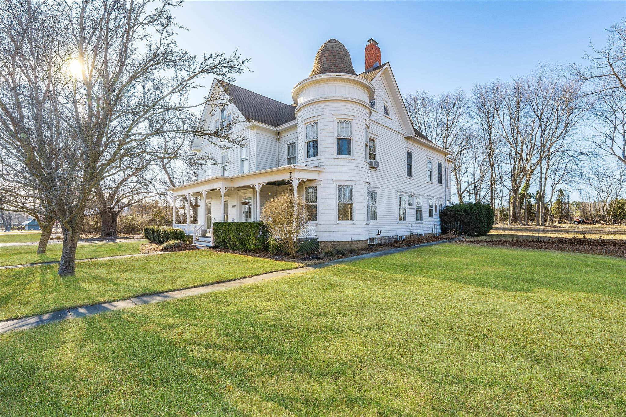 a big house with a big yard and large trees