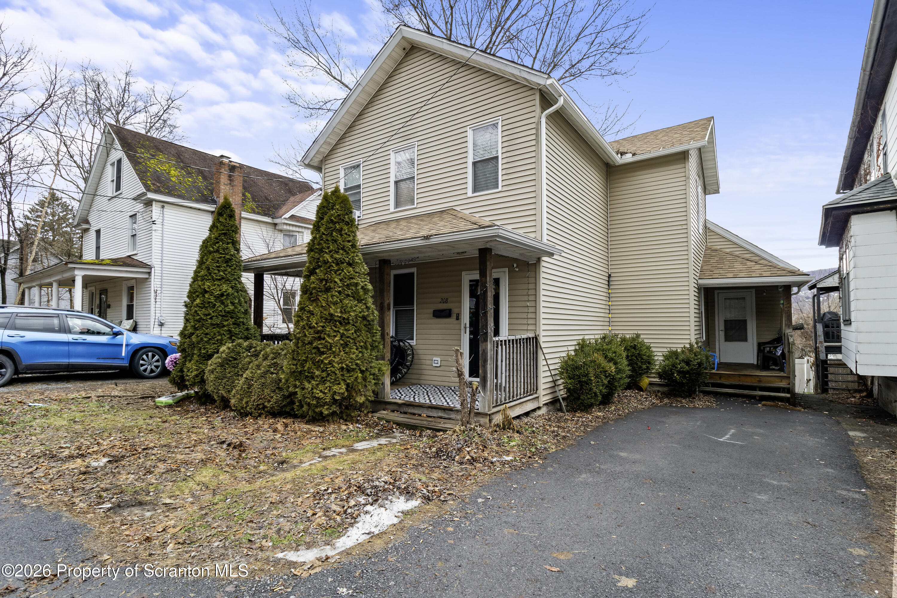 a view of a house with a yard and lawn chairs
