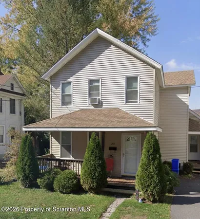 a view of a house with a yard and plants