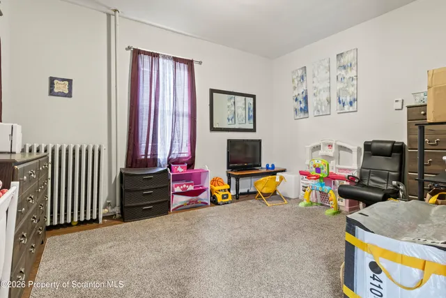 a living room with furniture and a dresser