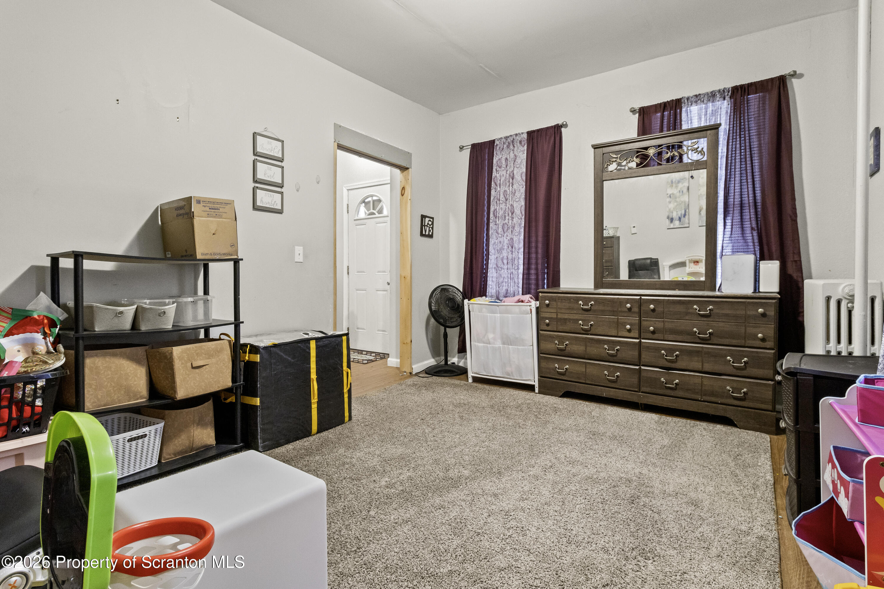 208 Sanderson Avenue Olyphant, PA 18447 - Photo 13 of 31 a living room with furniture and a dresser