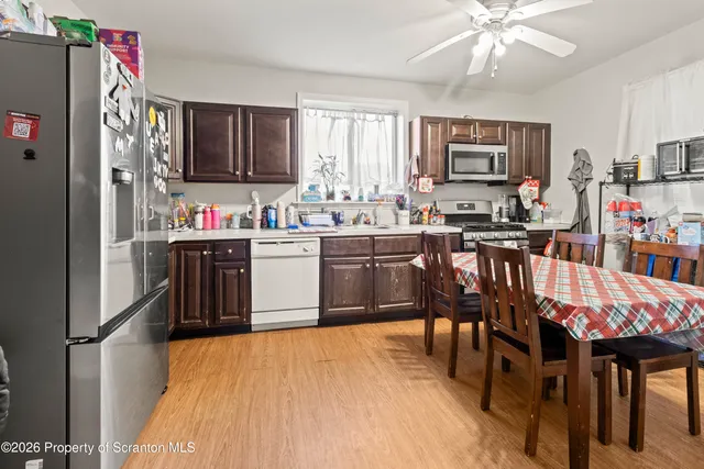 a kitchen with stainless steel appliances granite countertop a stove a sink dishwasher and cabinets