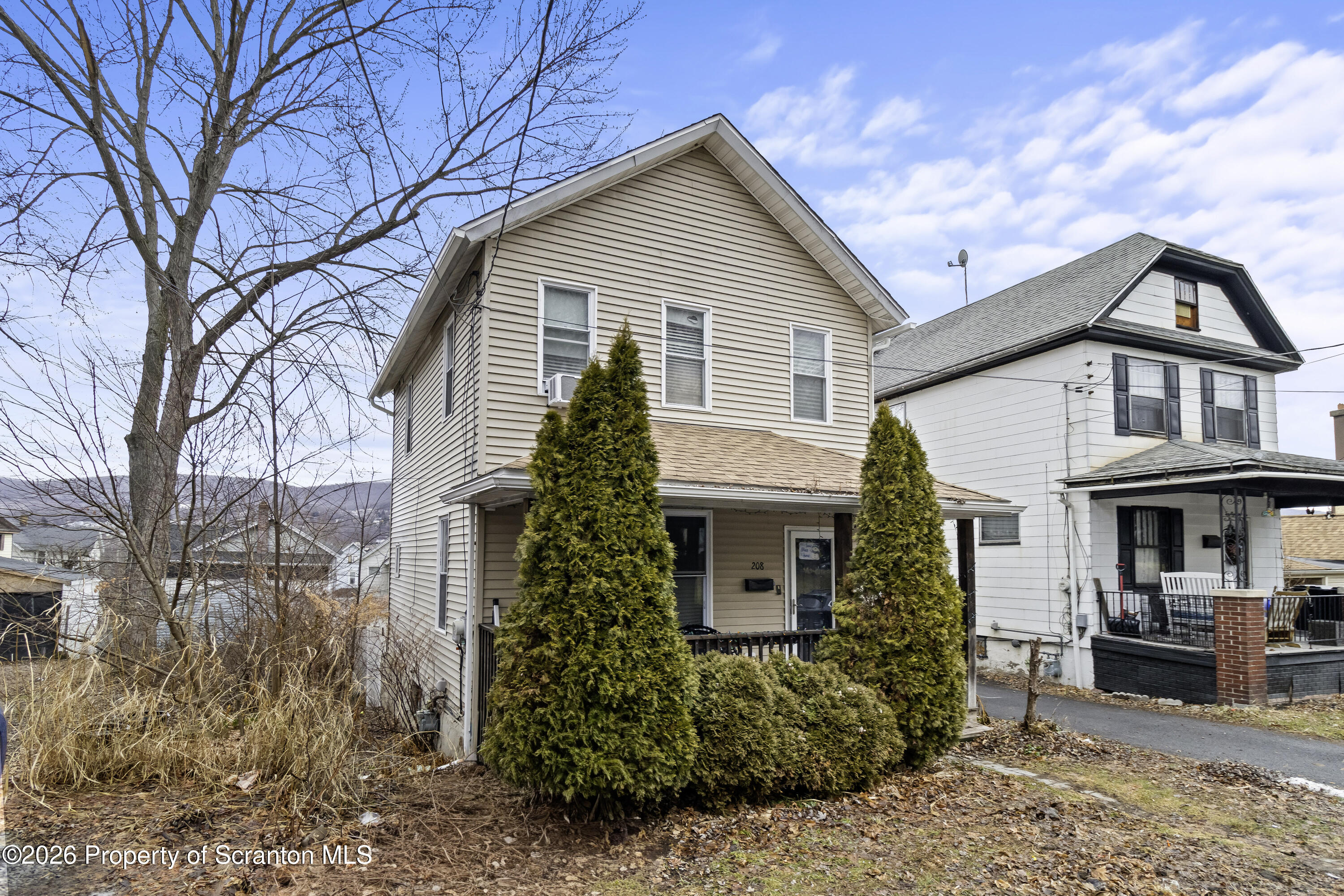208 Sanderson Avenue Olyphant, PA 18447 - Photo 2 of 31 a front view of a house with garden