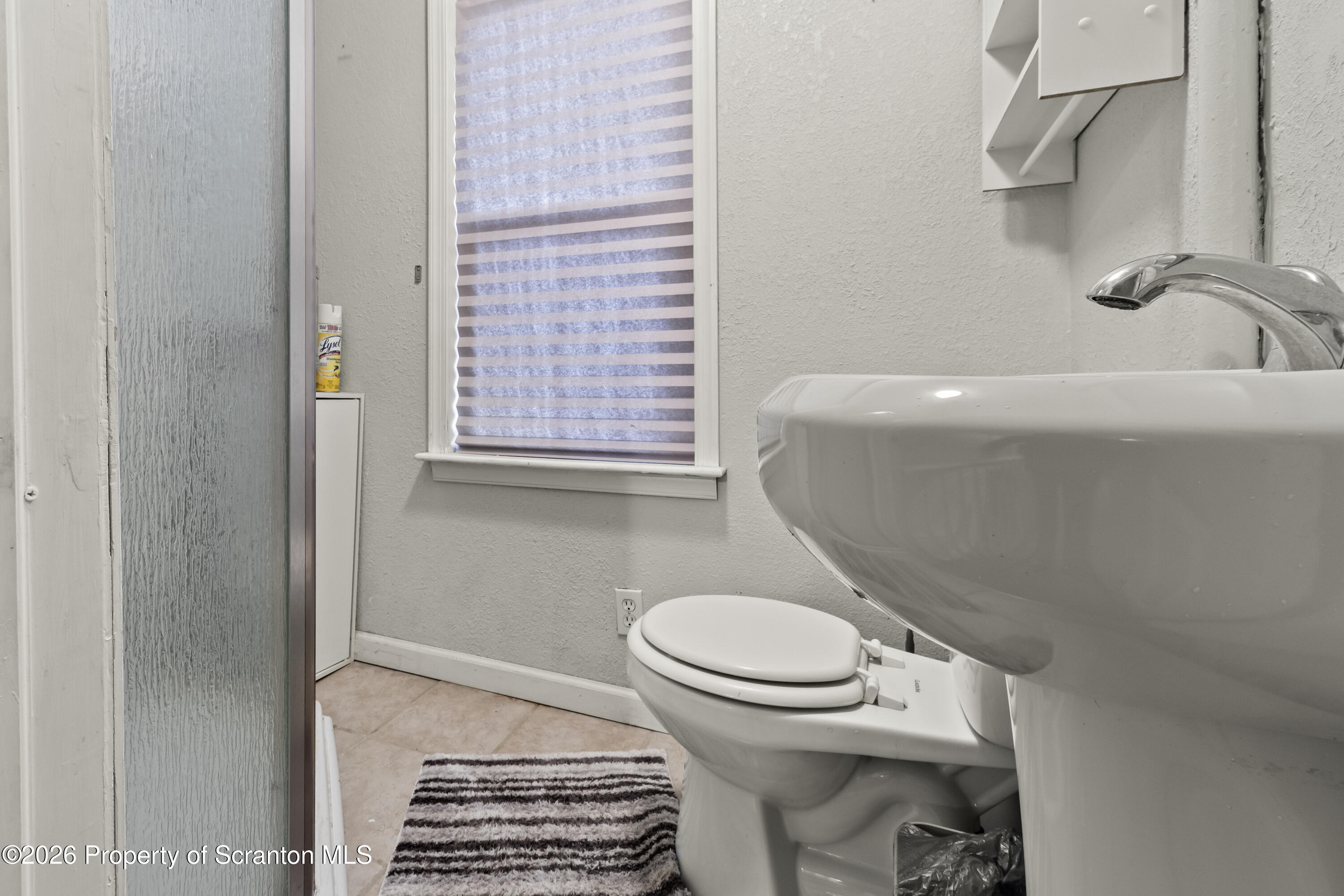 208 Sanderson Avenue Olyphant, PA 18447 - Photo 22 of 31 a bathroom with a sink and a toilet