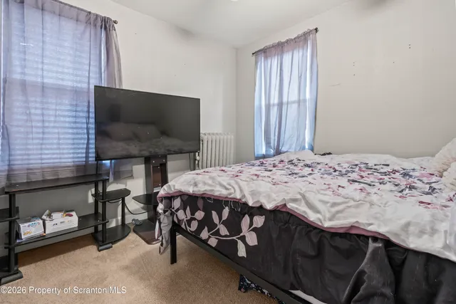 a bedroom with a bed and a mirror