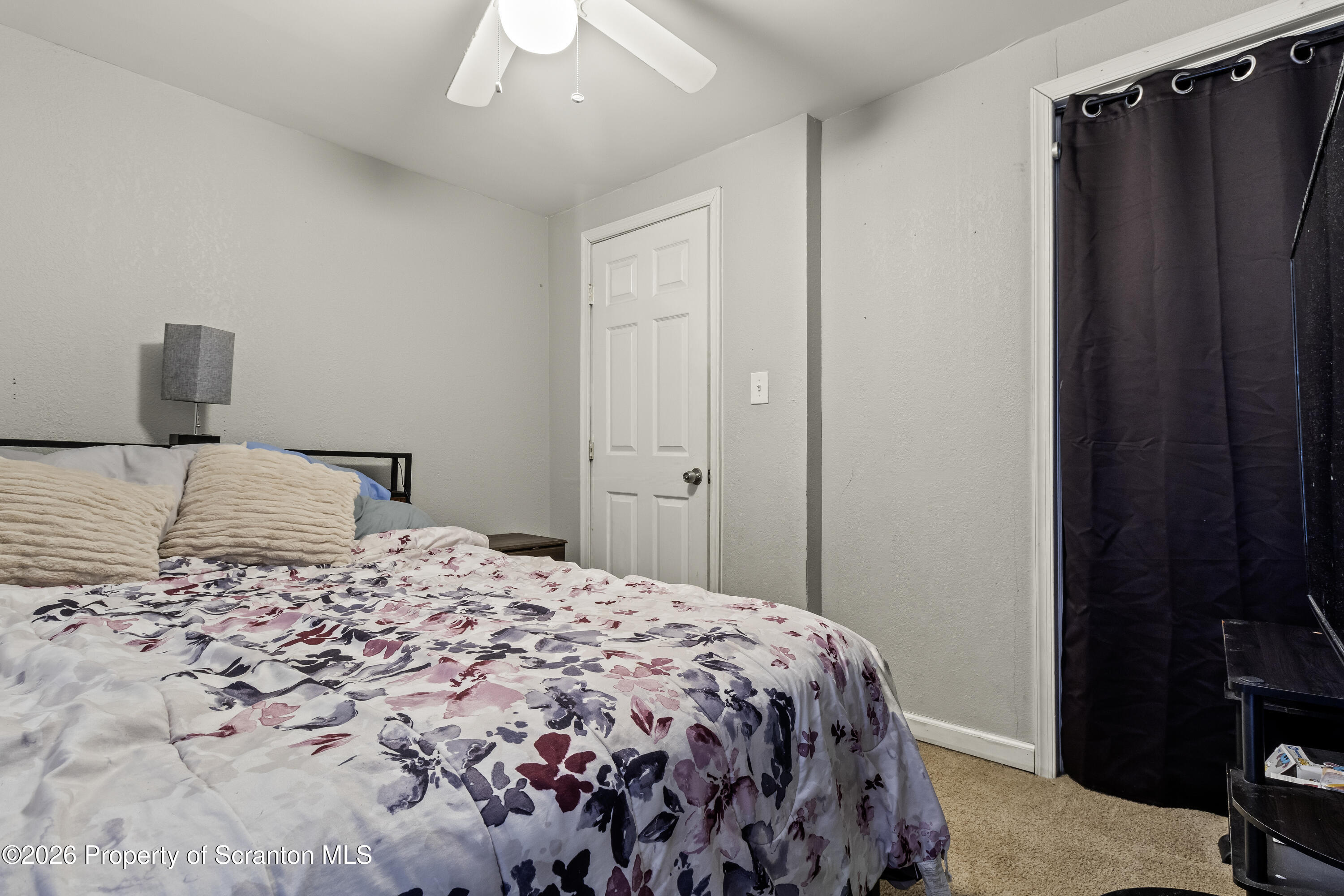 208 Sanderson Avenue Olyphant, PA 18447 - Photo 24 of 31 a bedroom with a bed and a mirror