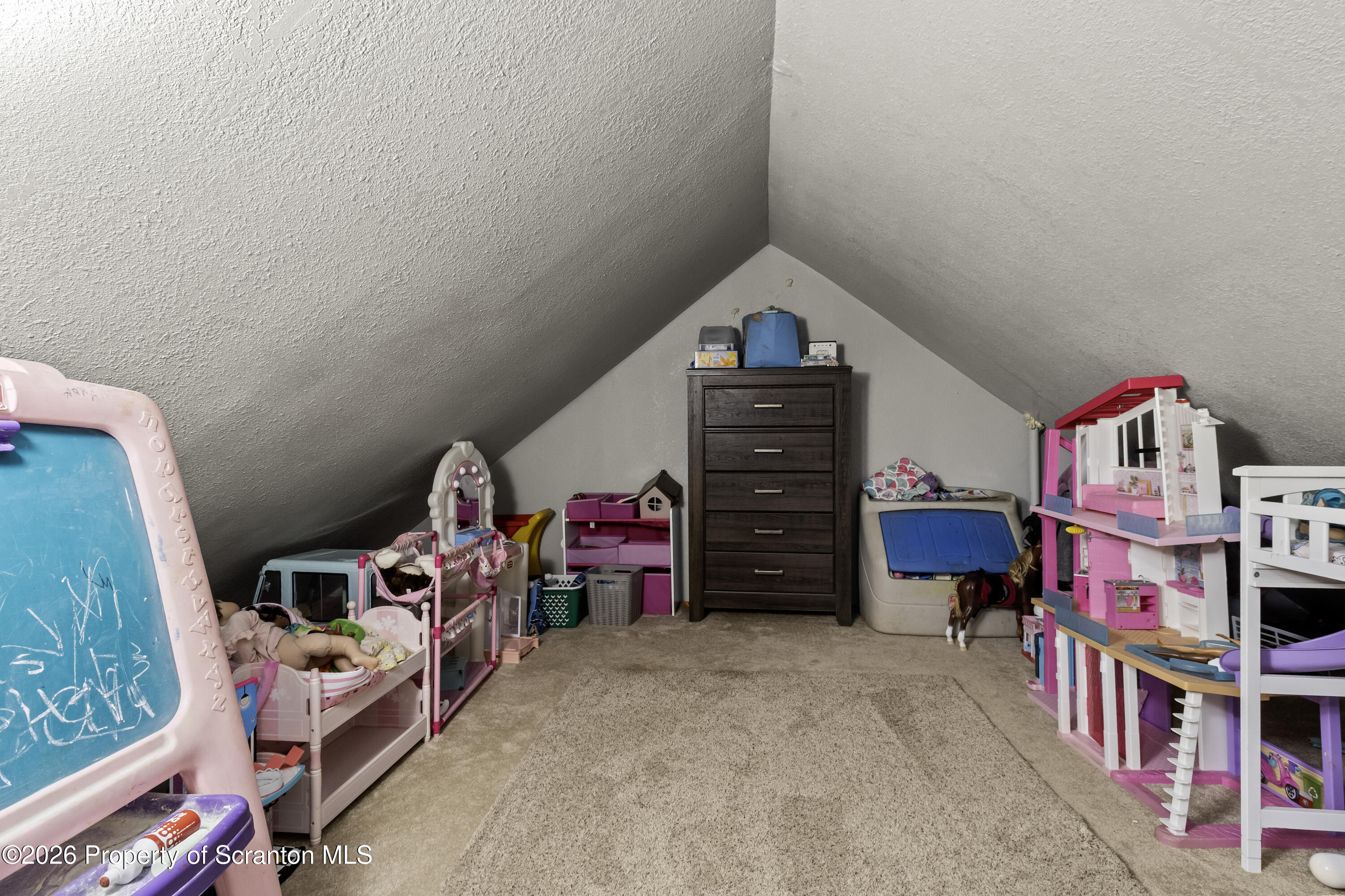 208 Sanderson Avenue Olyphant, PA 18447 - Photo 25 of 31 a children room with toys and a book shelf