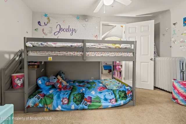 a bedroom with furniture and a flat screen tv