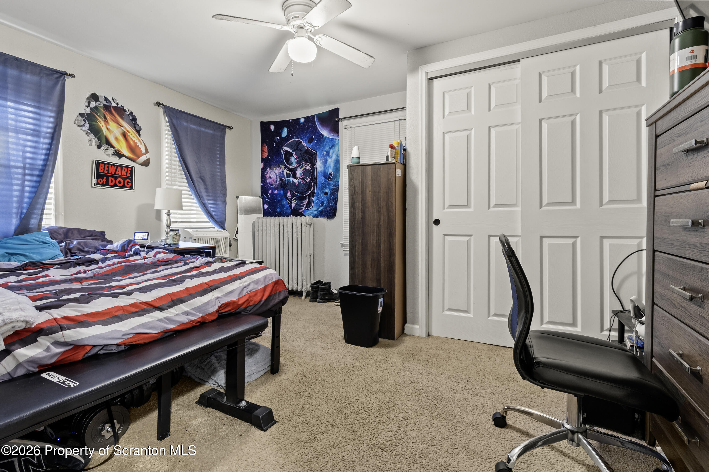 208 Sanderson Avenue Olyphant, PA 18447 - Photo 9 of 31 a bedroom with a bed and a chandelier