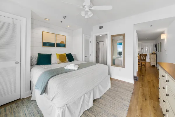 a bedroom with a bed and a large window