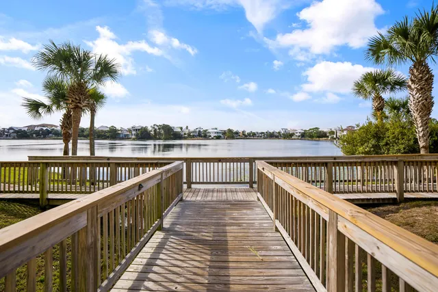 a view of a lake with couches in the patio