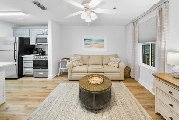 a living room with furniture and a wooden floor