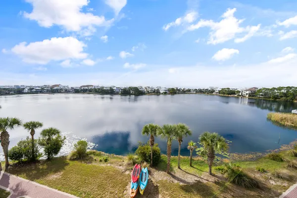 an aerial view of a house with a yard and lake