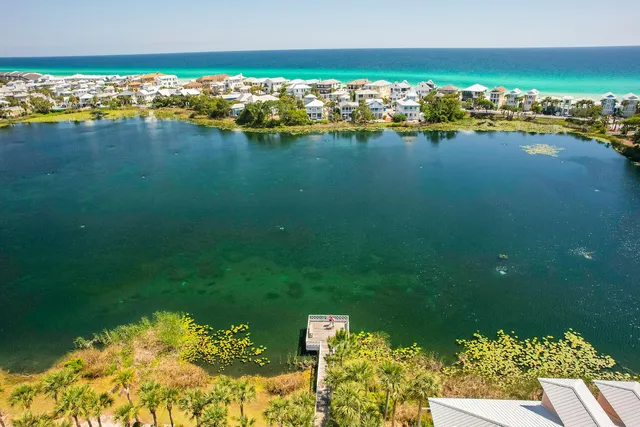 an aerial view of a houses with ocean view