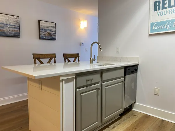 a living room with furniture a flat screen tv and a table