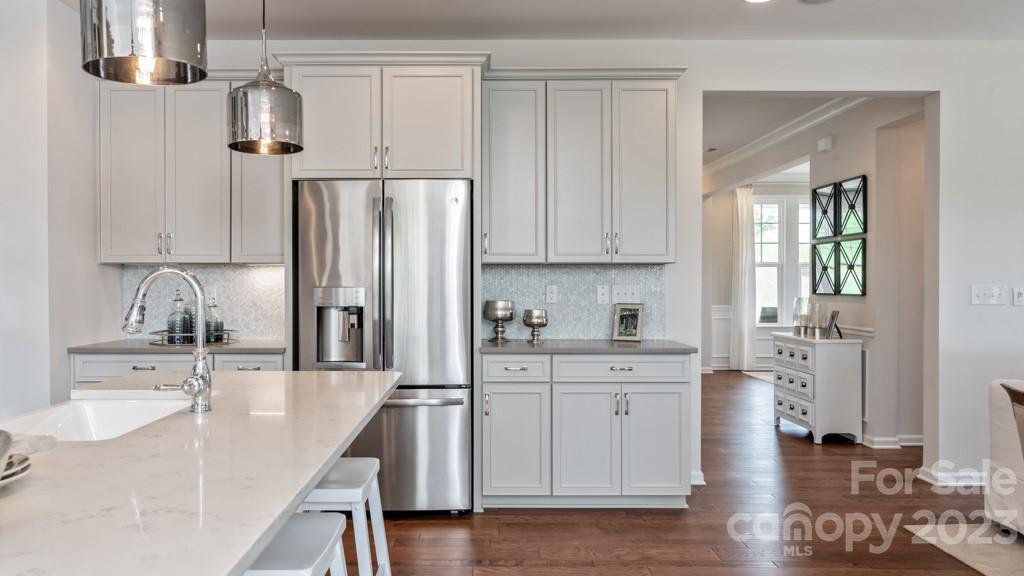 13219 Chopin Ridge Road Huntersville, NC 28078 - Photo 12 of 37 a kitchen with stainless steel appliances granite countertop a sink refrigerator and cabinets