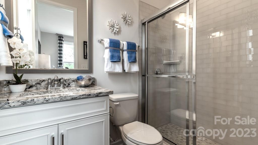 13219 Chopin Ridge Road Huntersville, NC 28078 - Photo 24 of 37 a bathroom with a granite countertop sink toilet and shower