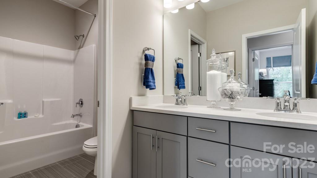 13219 Chopin Ridge Road Huntersville, NC 28078 - Photo 28 of 37 a bathroom with a double vanity sink toilet mirror and bathtub
