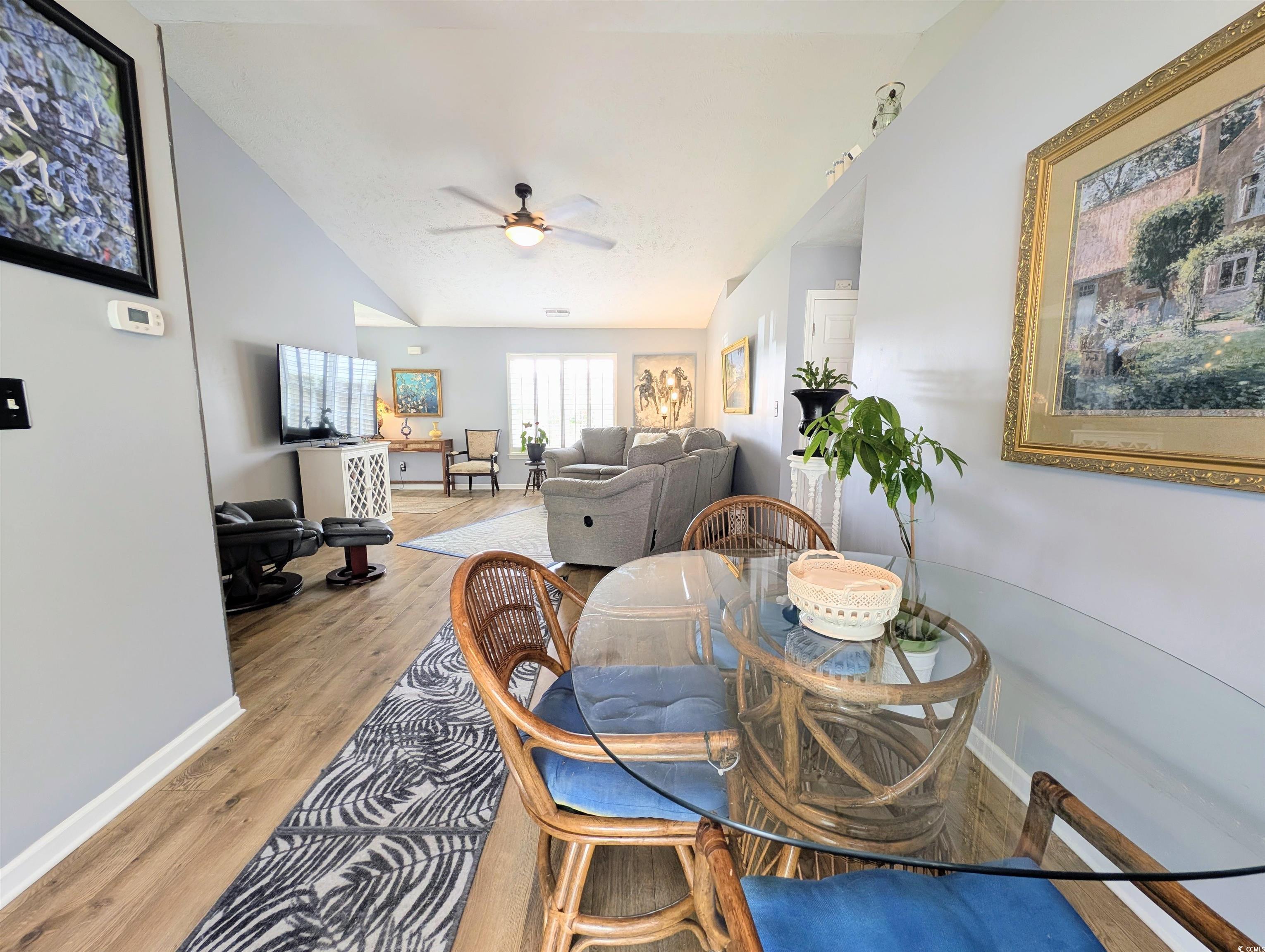 1013 Autumn Drive Murrells Inlet, SC 29576 - Photo 12 of 36 Dining space with light wood-type flooring, vaulted ceilings and open to the living room.