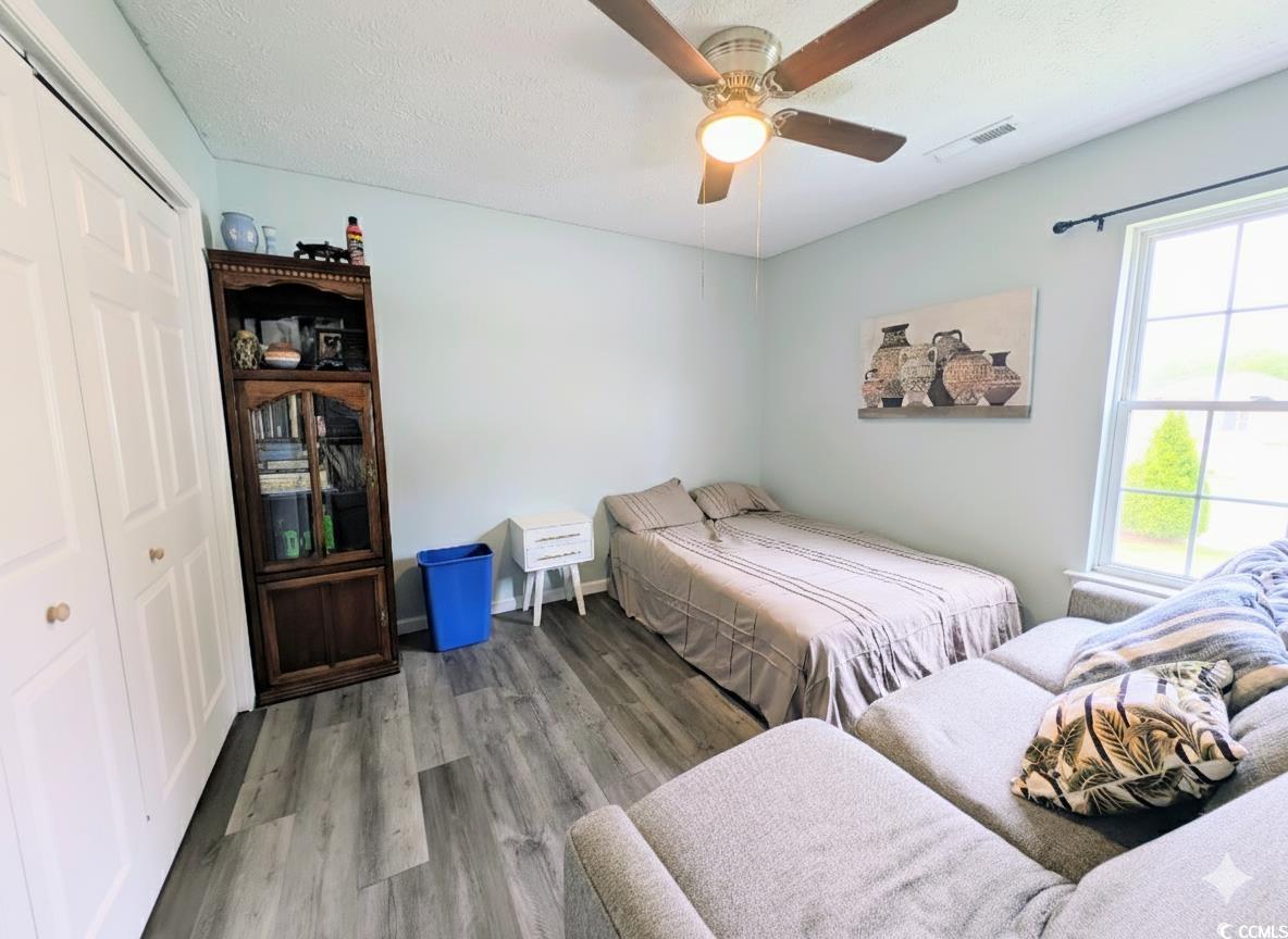 1013 Autumn Drive Murrells Inlet, SC 29576 - Photo 16 of 36 Bedroom with a closet, wood finished floors, a textured ceiling, and a ceiling fan