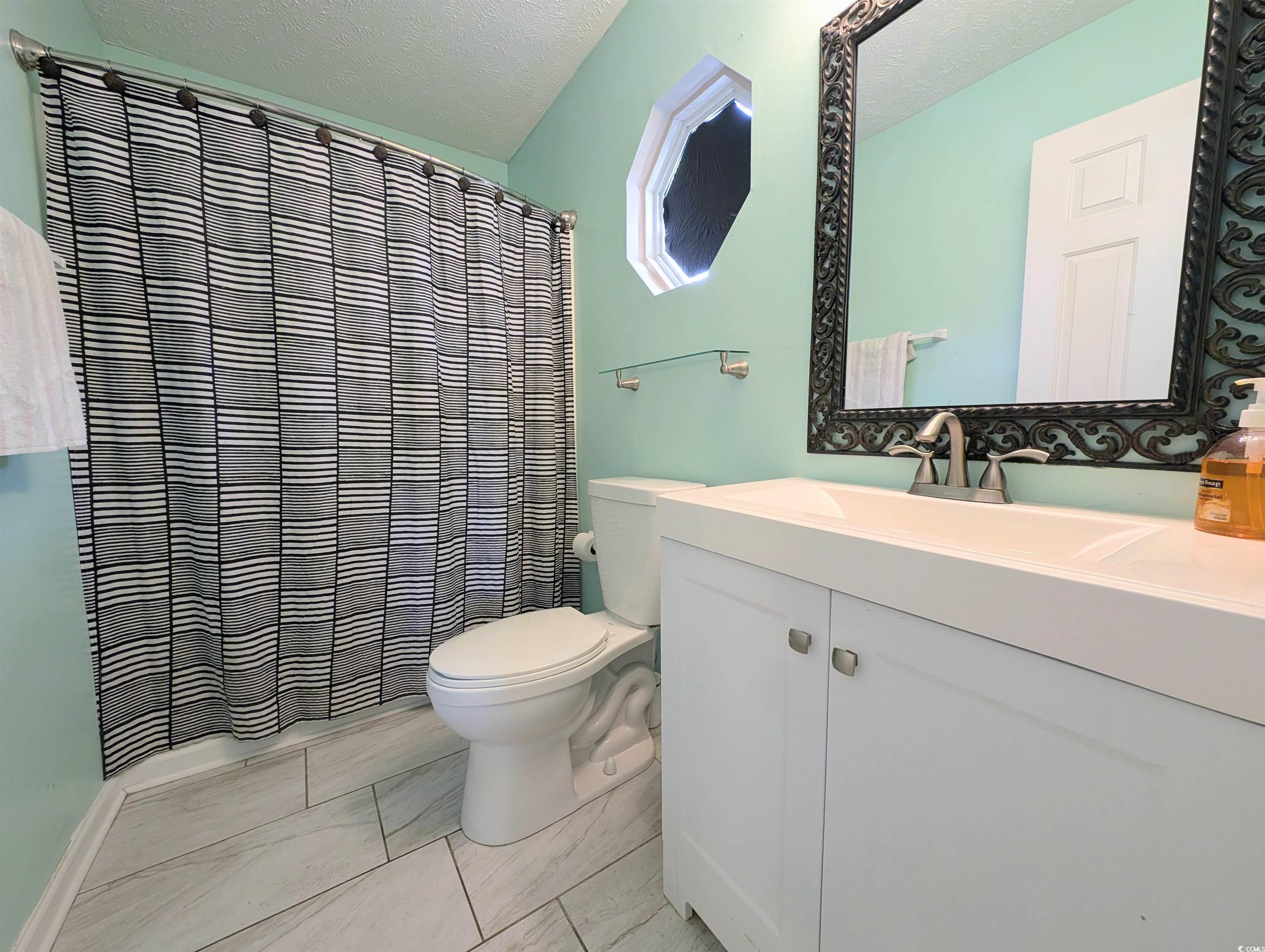 1013 Autumn Drive Murrells Inlet, SC 29576 - Photo 22 of 36 Bathroom featuring a tub/shower, vanity attached to main bedroom.