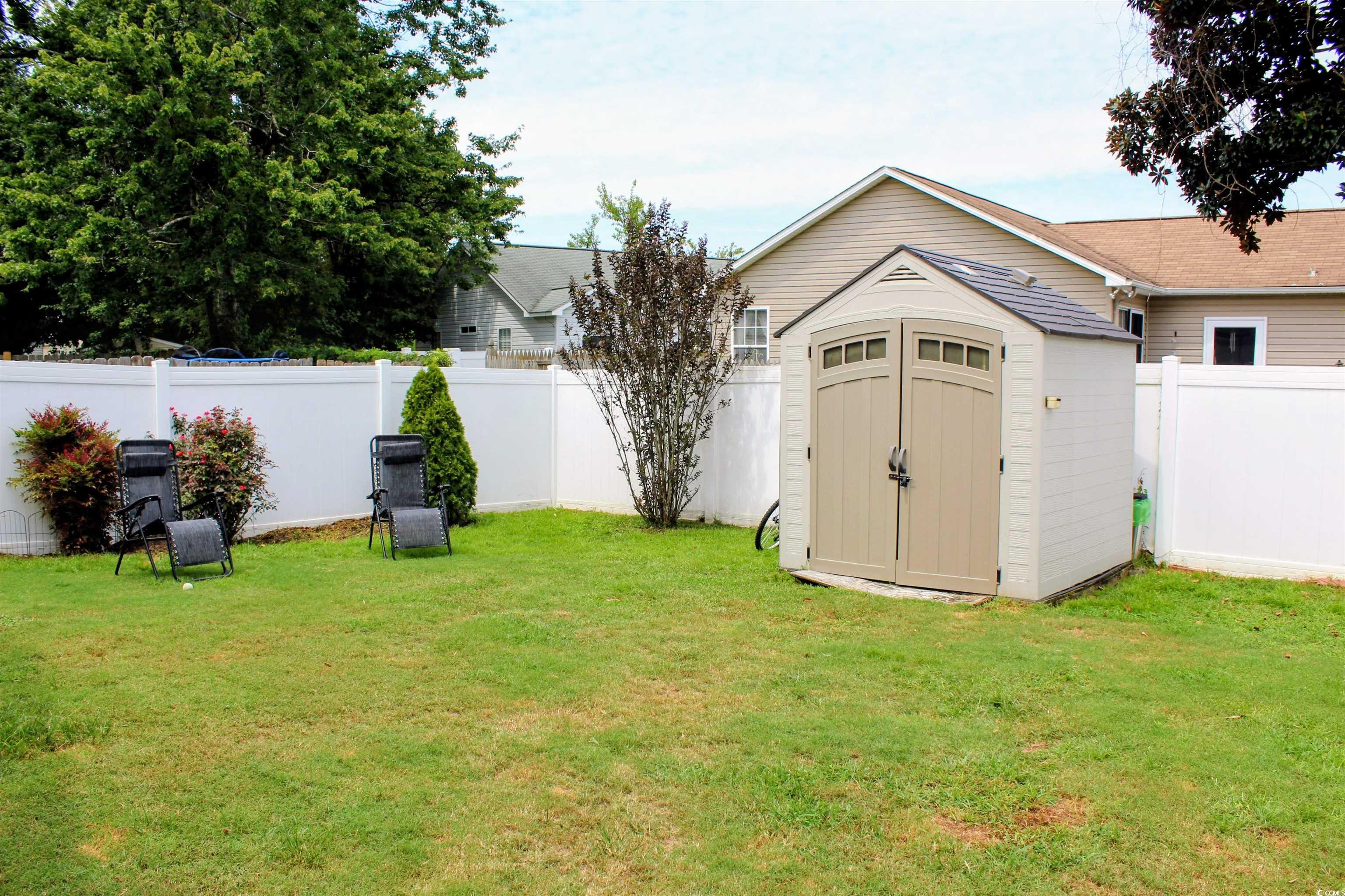 1013 Autumn Drive Murrells Inlet, SC 29576 - Photo 26 of 36 Fenced backyard with a detached shed for storage.