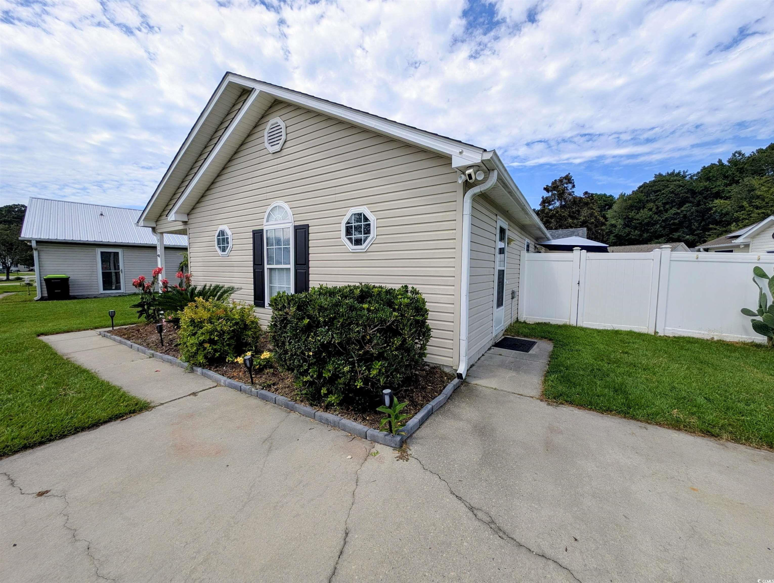 1013 Autumn Drive Murrells Inlet, SC 29576 - Photo 29 of 36 View of side of property with a lawn and a gate