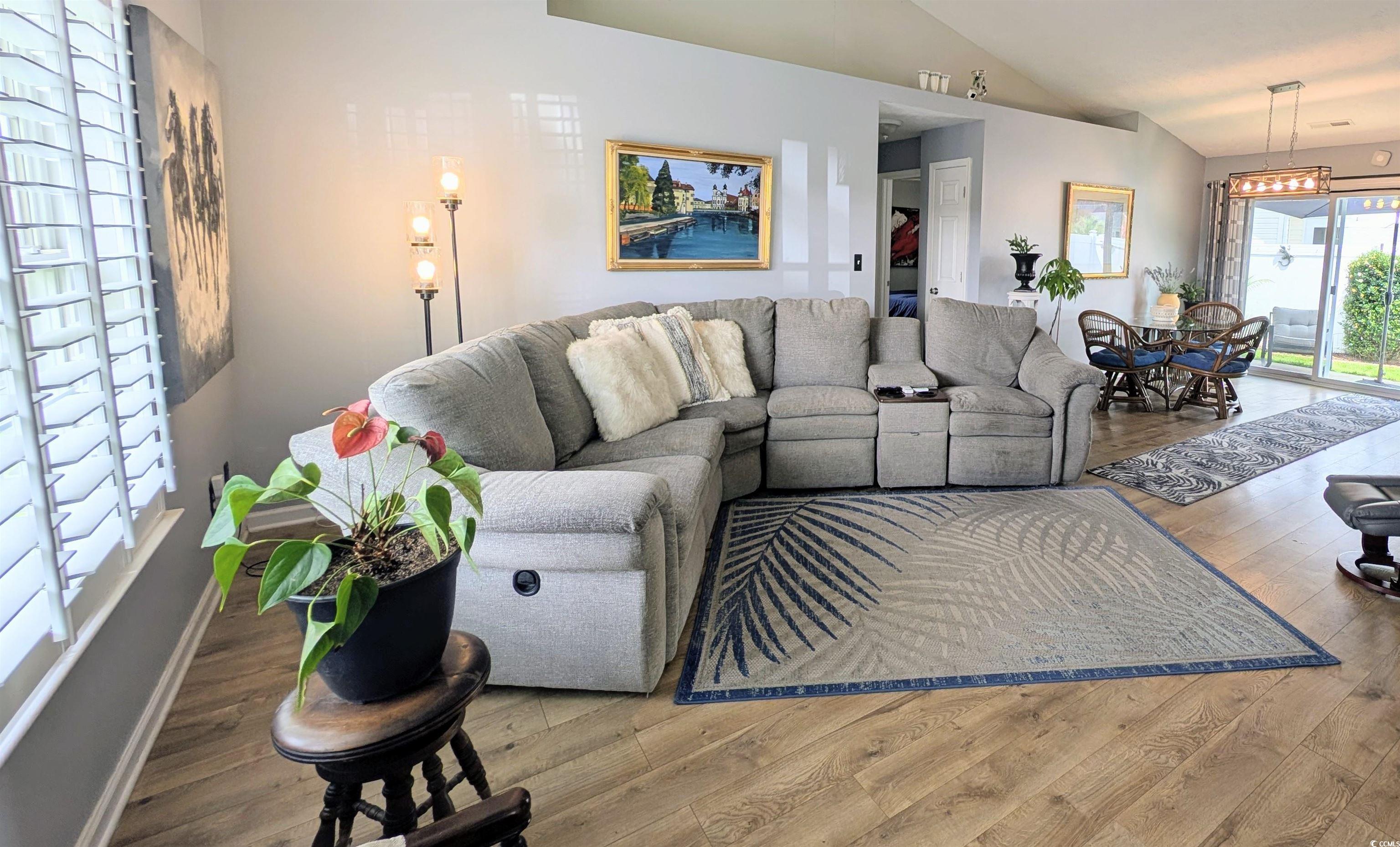 1013 Autumn Drive Murrells Inlet, SC 29576 - Photo 6 of 36 Living room featuring vaulted ceiling and wood finished floors