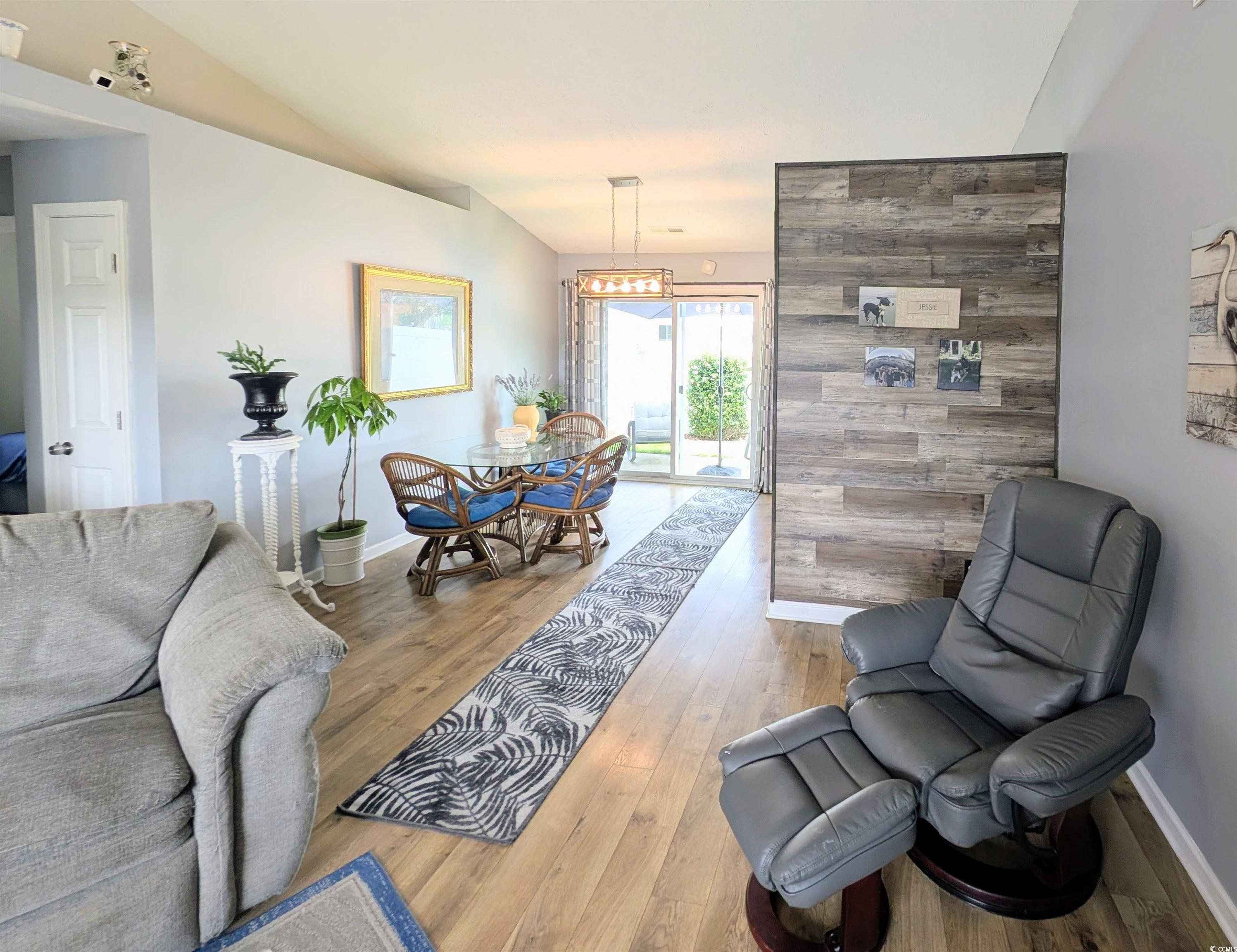 1013 Autumn Drive Murrells Inlet, SC 29576 - Photo 8 of 36 Living area featuring wood finished floors and baseboards