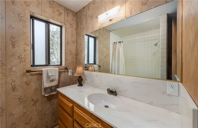 a bathroom with a sink and a mirror