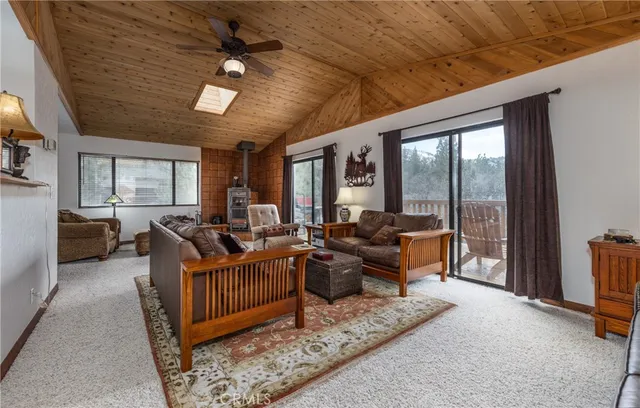 a living room with furniture ceiling fan and a rug