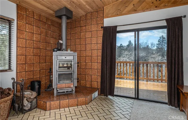 a view of a livingroom with furniture and floor to ceiling window