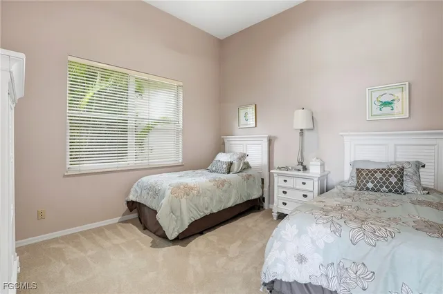 a bedroom with two beds and a window