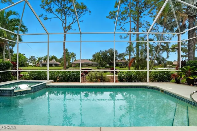a view of a swimming pool with a yard