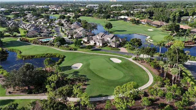 an aerial view of a house with a garden and lake view