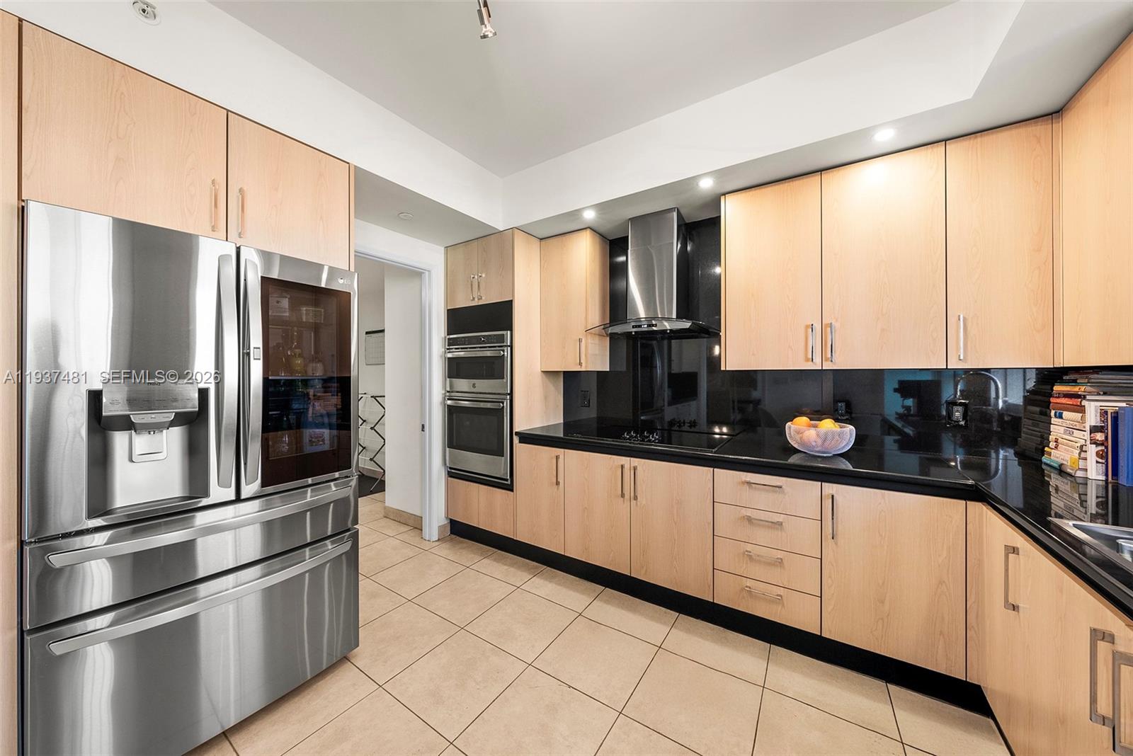 781 Crandon Boulevard, Unit 804 Key Biscayne, FL 33149 - Photo 21 of 50 a kitchen with stainless steel appliances granite countertop a refrigerator and a sink