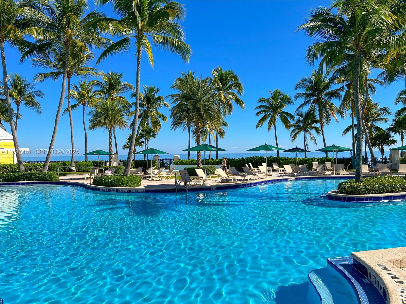 781 Crandon Boulevard, Unit 804 Key Biscayne, FL 33149 - Photo 36 of 50 a view of a swimming pool and a yard