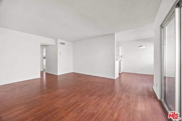 a view of an empty room and wooden floor
