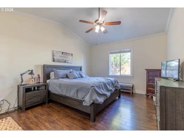 a spacious bedroom with a bed and a chandelier