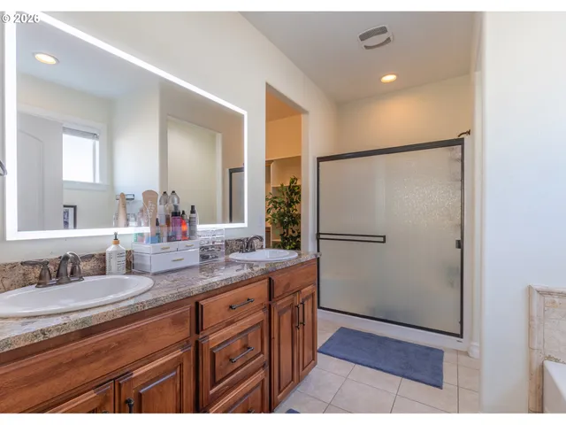 a spacious bathroom with a granite countertop sink mirror and double