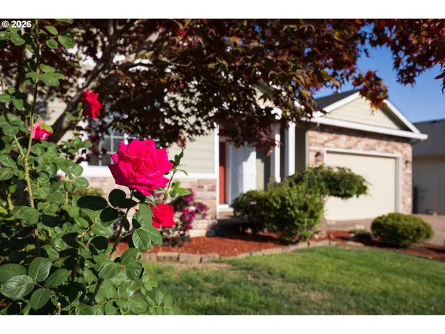a view of a house with a flower garden